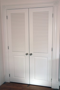 Hinged doors with wider stiles to hold knobs