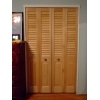 louvered doors with a colonial raised panel