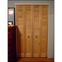 louvered doors with a colonial raised panel