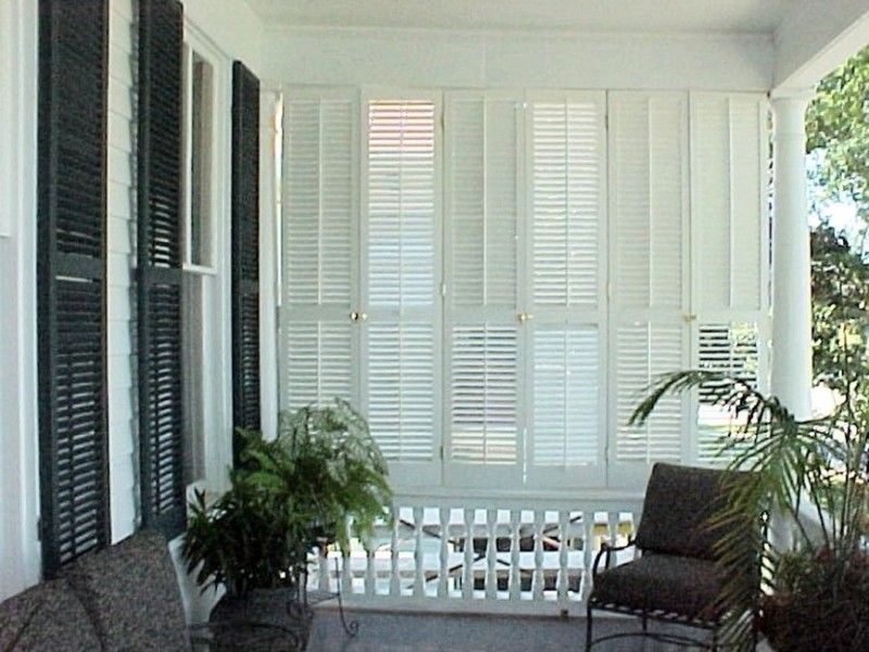 operable louvered exterior shutters enclosing a porch